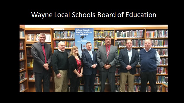 people standing in front of library shelves